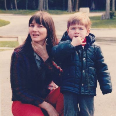 Mother is posing while Torrance is distracted by something else in this childhood picture of his